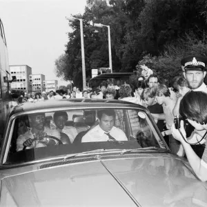 Muhammad Ali in the passenger seat makes his way through Coventry mobbed by fans Muhammad Ali in the passenger seat makes his way through Coventry mobbed by fans