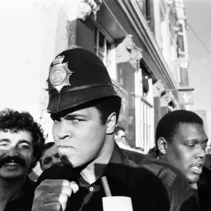 Muhammad Ali seen here on a visit to the UK poses wearing a policemans helmet Muhammad Ali seen here on a visit to the UK poses wearing a policemans helmet