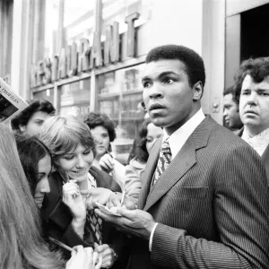 Muhammad Ali signing autographs ahead of his rematch with Joe Frazier. January 1974