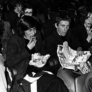 Music fans eat their fish and chips at the Sophia Gardens Pavilion in Cardiff whilst