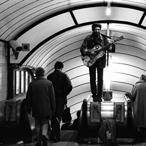 A musician busking at Oxford Circus Station - February 1987 standing