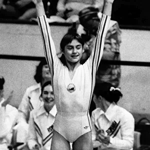 Nadia Comaneci July 1976 Romanian genius No 73 ia applauded by her team mates as