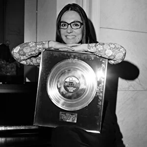 Nana Mouskouri, International Singing Star, is presented with a gold disc for her LP