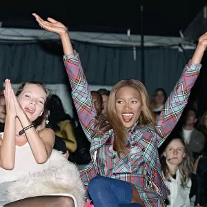 Naomi Campbell model sitting next to supermodel Kate Moss cheers a winner at British