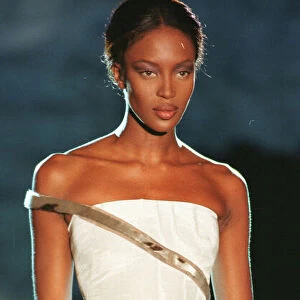 Naomi Campbell modelling white strapless evening dress as part of Donatella Versace