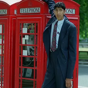 Naseer Ahmed Soomro claims to be World Tallest Man 1999 stands next to a red