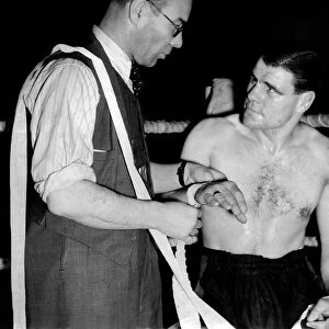 Nat sellars bandaging Vince Hawkins. November 1946 P009909