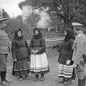 Native women of Halicz in Galacia talk with soldiers of the Russian army during World War
