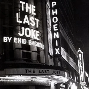 Neon lights advertise the play "The Last Joke"