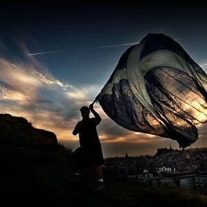 New Dawn September 1997 a man holding waving a Saltire flag at sunrise in Edinburgh