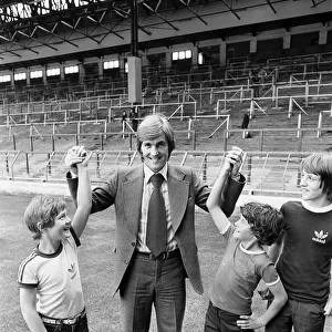 New Liverpool signing Kenny Dalglish with fans on the pitch at Anfield as he completes