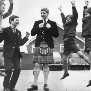 Black and white print of Ken Buchanan in tartan Highland fling attire
