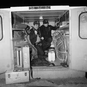 Two New York Policemen in the back of their truck with their equipment Two New York Policemen in the back of their truck with their equipment