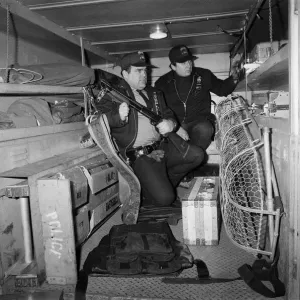 Two New York Policemen in the back of their truck with their equipment Two New York Policemen in the back of their truck with their equipment