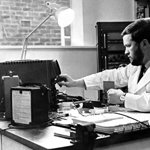 Newcastle General Hospital. An electronic technician tests neurophysiology apparatus in