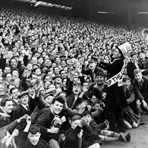 Newcastle mascot Jimmy Nichol leads the cheers of the Newcastle crowd before the game