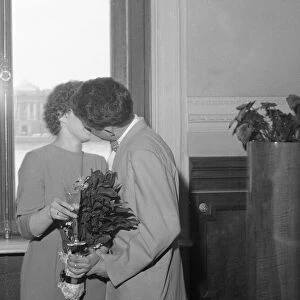 A newly married Russian couple kissing in the registrar office in Leningrad
