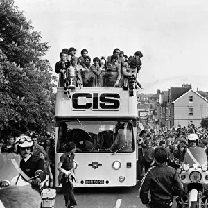 Newport County football team ride through the crowd-lined streets of the town to