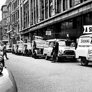 Newspaper printing. Delivery vans of the London evening News wait for the paper to roll