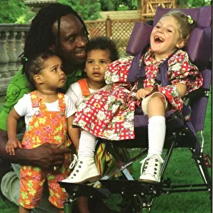 Nigel Benn former boxer with his twins India and Connor and their friend Kelly
