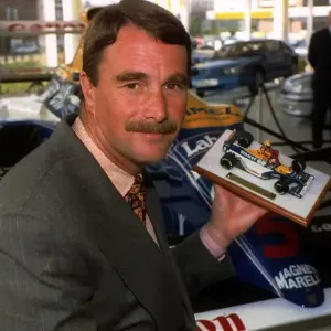 Nigel Mansell Formula One racing driver with a model of himself Nigel Mansell Formula One racing driver with a model of himself