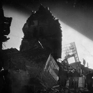 Night rescue by searchlight after a V Bomb in South England recently. December 1944
