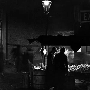 A night scene in Portobello Road market London. 8th October 1936