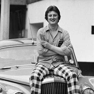 Nineteen year old dart player Eric Bristow poses in London sitting on top of a Rolls
