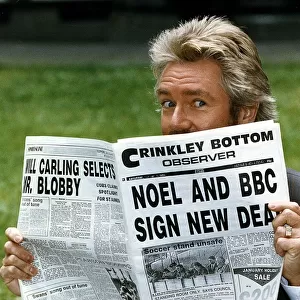 Noel Edmonds Tv Presenter reading newspaper called the Crinkley Bottom Observer after