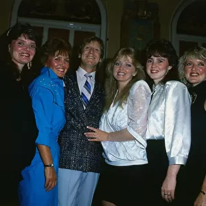 The Nolans pop group pose with English singer Joe Longthorne. Circa 1989