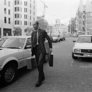 Norman Tebbit arrives with three despatch boxes at the Department of Trade, Victoria Norman Tebbit arrives with three despatch boxes at the Department of Trade, Victoria