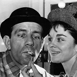 Norman Wisdom gets a light from co-star Sally Smith. August 1964 P009831
