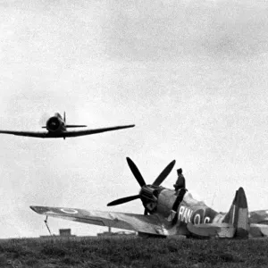 A North American Harvard dual control training aircraft passes over a Supermarine A North American Harvard dual control training aircraft passes over a Supermarine