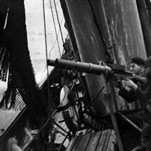 North Sea trawlerman, gunner - fisherman Liston (left) in action with a Lewis gun to
