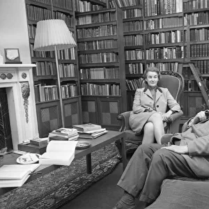 Novelist J. B. Priestley in the library of his home with his wife Jacquetta Hawkes at