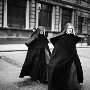 Two nuns crossing the road in Liverpool, Merseyside. Circa 1967
