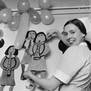 A Nurse Decorates a Children's Hospital Print 20th December 1975