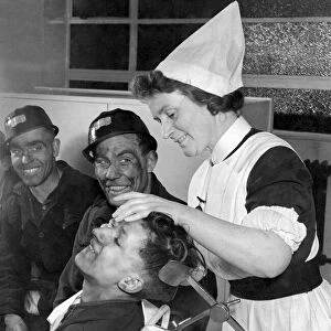 Nurse helps miners beat their target. Miners queue up in the pithead surgery as Sister