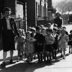 A nurse of Pimlico Day nursery takes the children out for a walk A nurse of Pimlico Day nursery takes the children out for a walk