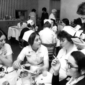 Black and white photograph print of nurses discussing meal costs
