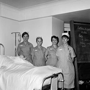 Nurses wearing new style uniforms. Left to right, Miss M McGrath, Miss W G Neville