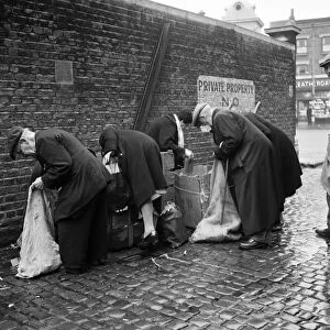 OAPs collecting firewood outside a furniture factory in Denmark Hill, London