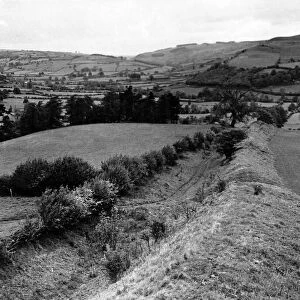 Offas Dyke is a large linear earthwork that roughly follows the current border