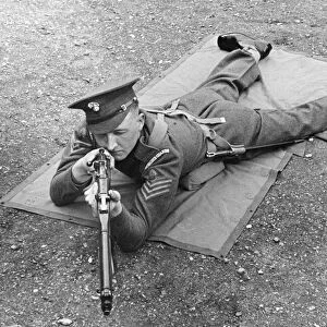 An officer from the Grenadier Guards in a laying combat position