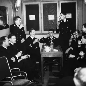 Officers of HMS Ajax and Exeter enjoying a drink during the interval at the London
