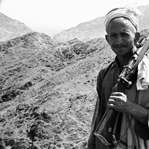 Old Pathan tribesman carries a old bolt action rifle at the Khyber Pass on the border