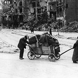 An old woman and her husband July 1945 trundle through the Leipzig Strasse of