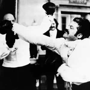 Oliver Reed actor as Bismark and Henry Cooper boxer - January 1975 In scene Oliver Reed actor as Bismark and Henry Cooper boxer - January 1975 In scene