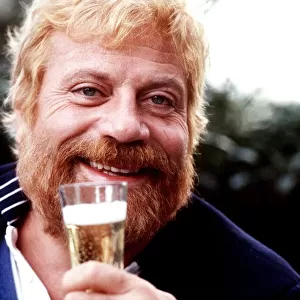 Oliver Reed drinks a glass of champagne 1986