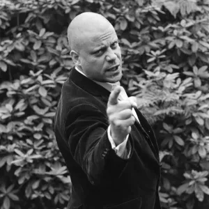Oliver Reed wearing his wig at his home in Wimbledon, South West, London